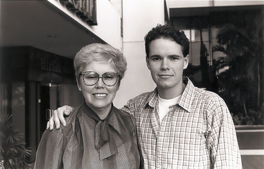 Faust with his arm around his mom, who is smiling
